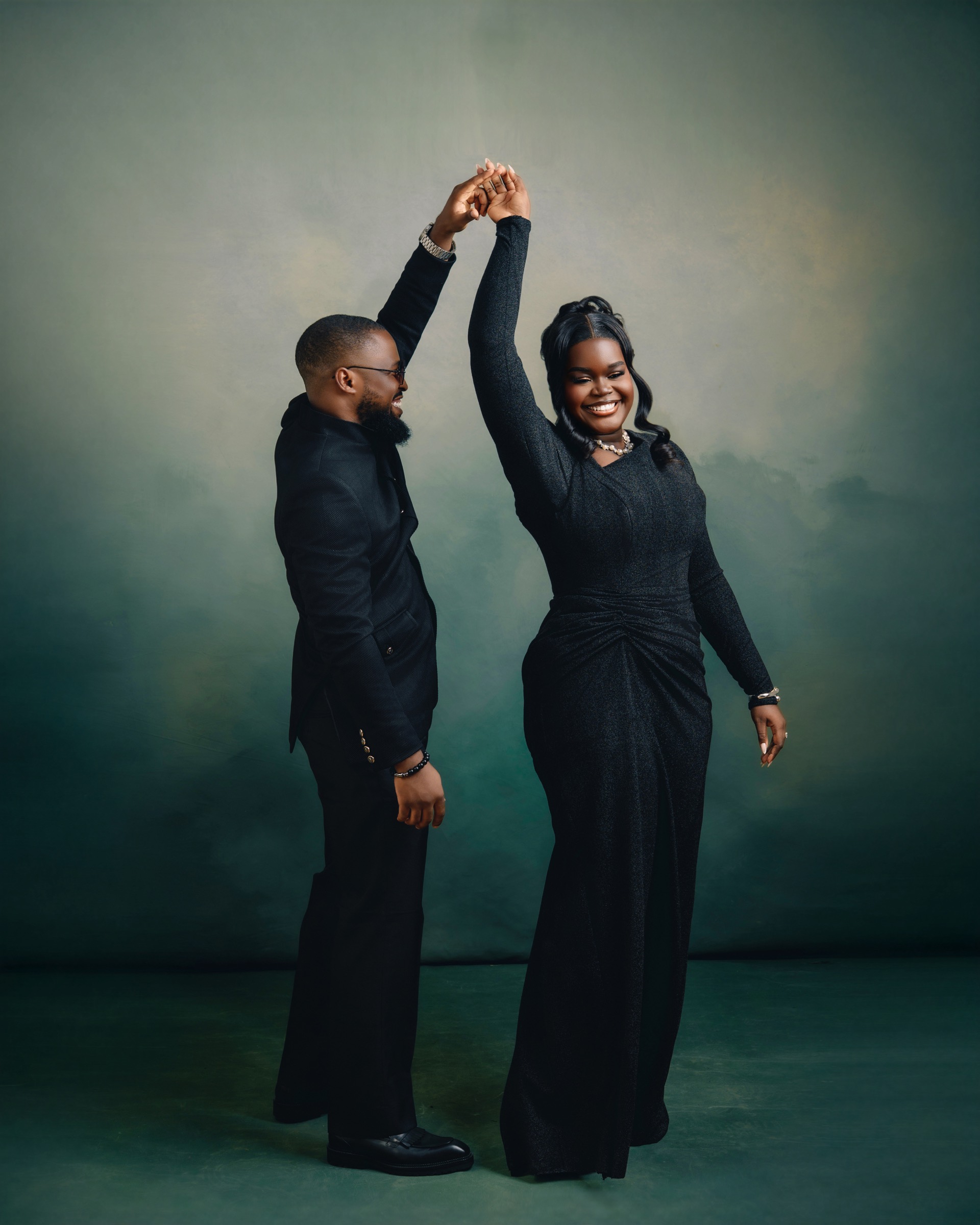 Uyoyou twirls Ehimwenma mid-dance, both in black