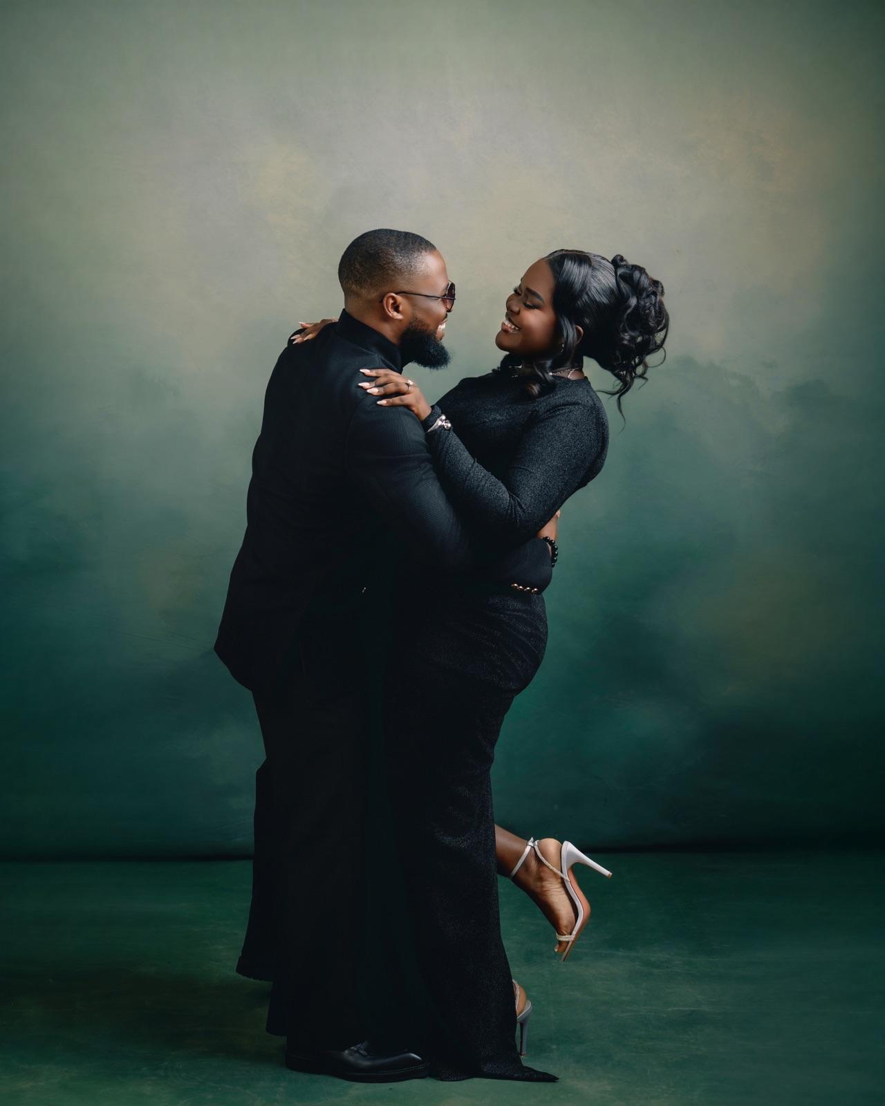 An embrace, one heel kicked up