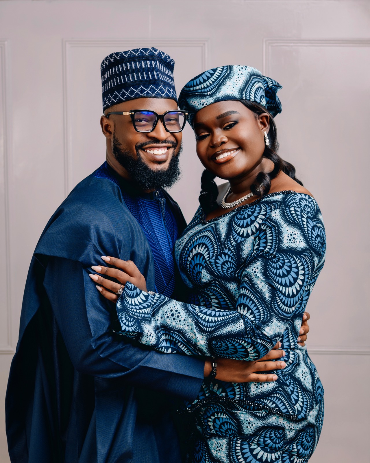 Embracing in traditional attire, smiling
